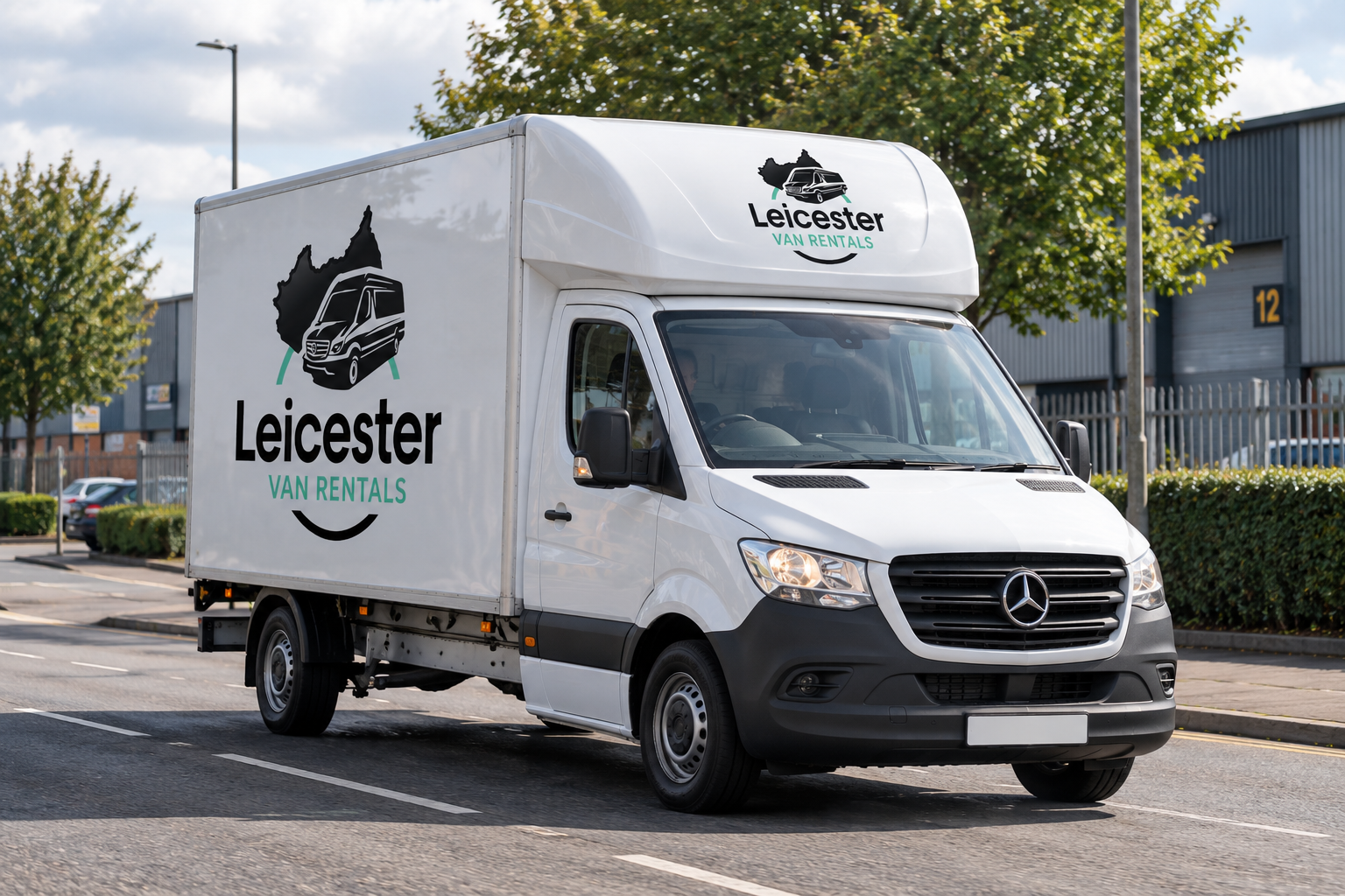 Leicester Van Rentals branded Luton van driving on a road in Leicester.
