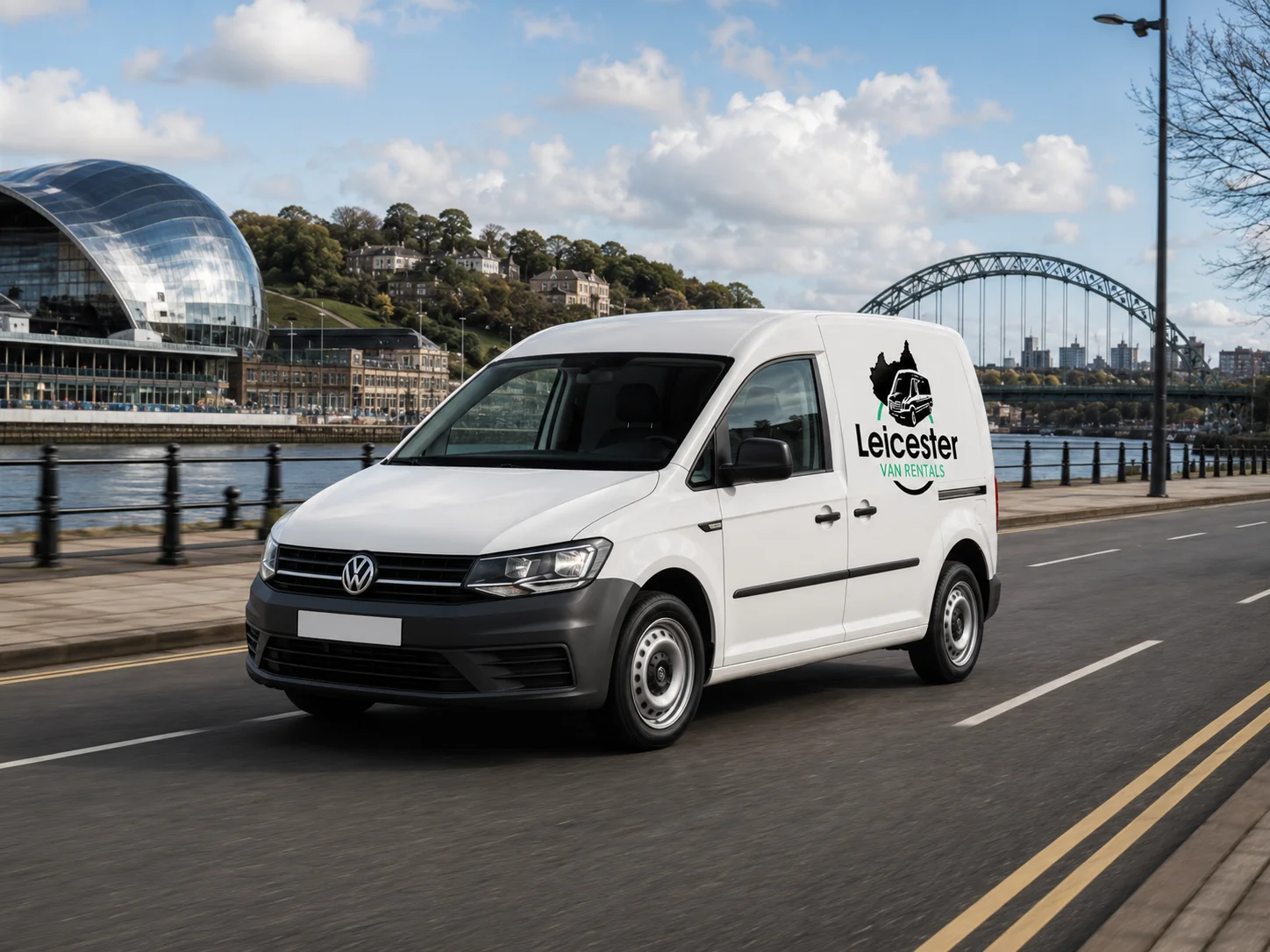 Leicester Van Rentals Small Van On The Road Small white Leicester Van Rentals van driving on a wet mountain road with snow-covered mountains in the background.